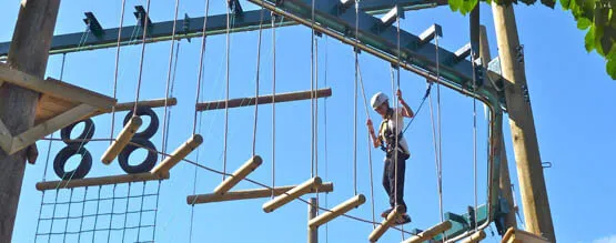 A student going through a high rope course built by oxo